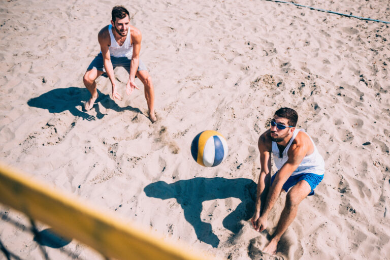 two guys playing beach volleyball