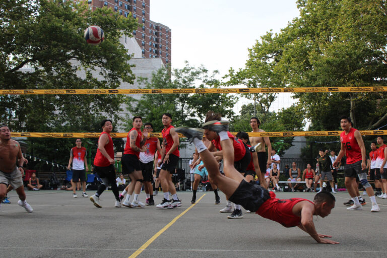 a player diving on concrete during a volleyball game