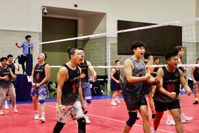 excited volleyball players celebrating a point